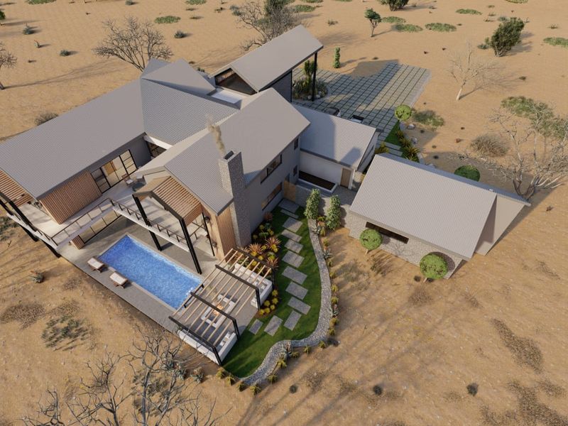 Aerial view of a modern architectural residence featuring a swimming pool, pergola, and stone accents set within a landscaped desert environment.