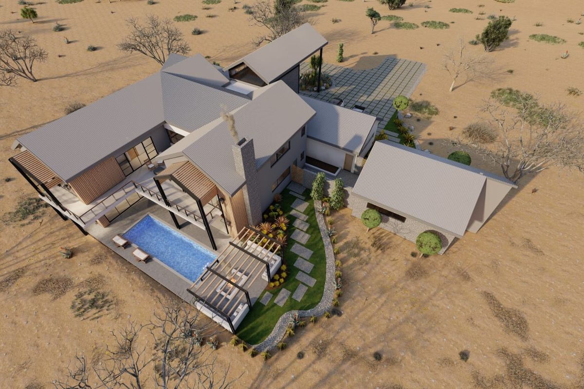 Aerial view of a modern architectural residence featuring a swimming pool, pergola, and stone accents set within a landscaped desert environment.