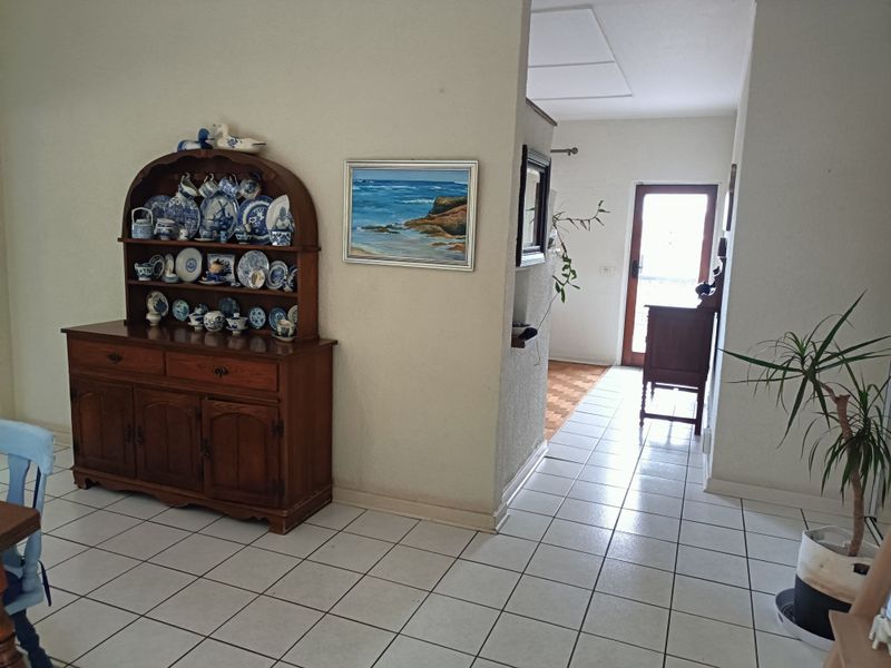 An entrance area featuring tiled flooring and a glass panelled door leading to the exterior.