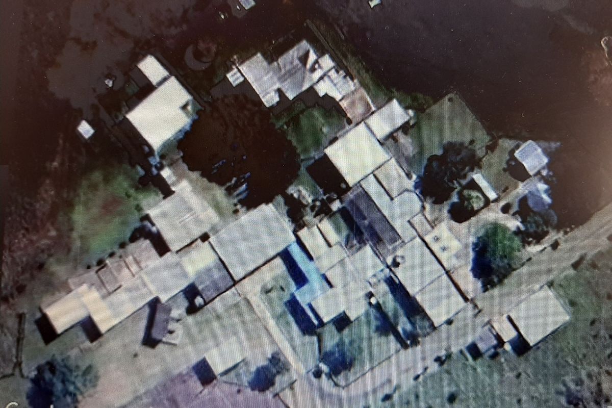 Aerial view of the farm property showing the layout of the main dwelling and various outbuildings on the land.