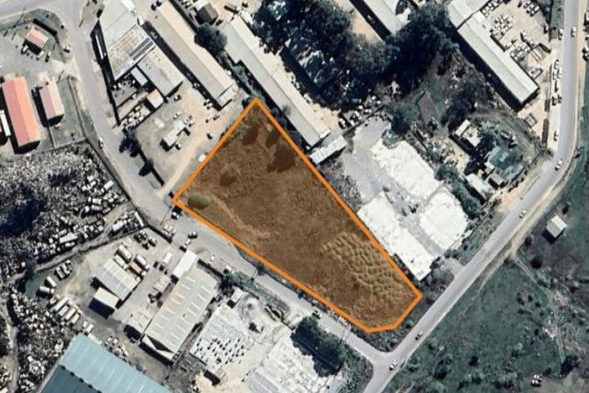 Aerial view of a vacant commercial land plot, highlighting the property boundaries within an established industrial area.