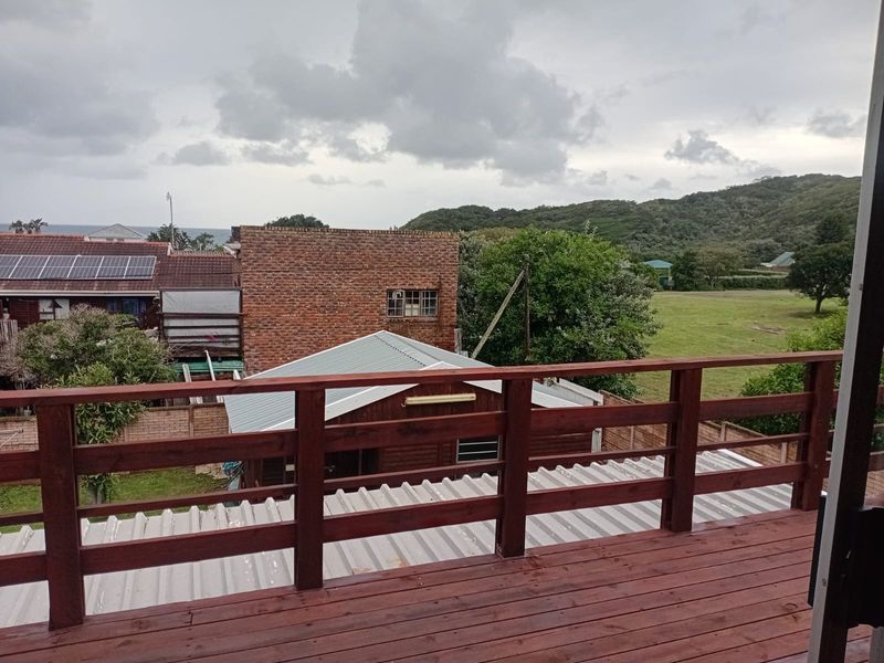 An elevated timber balcony offering scenic views of the surrounding neighbourhood and landscape.