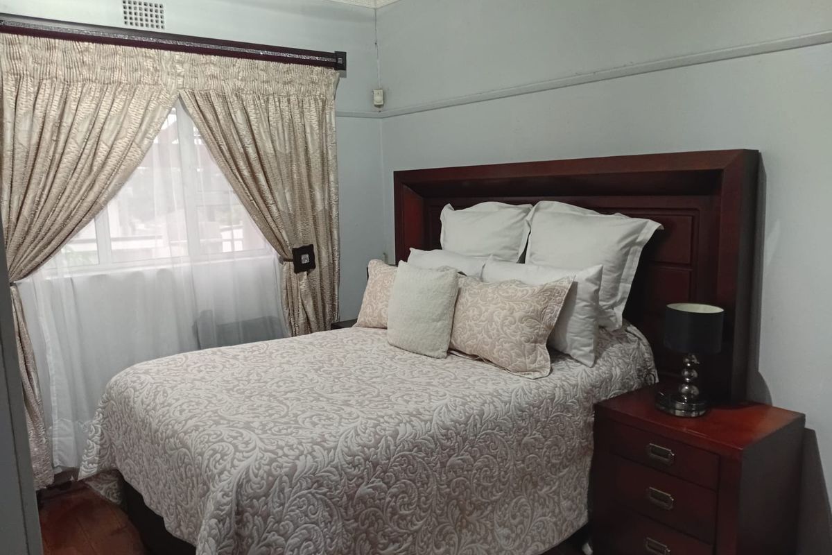A bedroom featuring hardwood flooring and decorative crown molding, providing a classic foundation for interior updates.