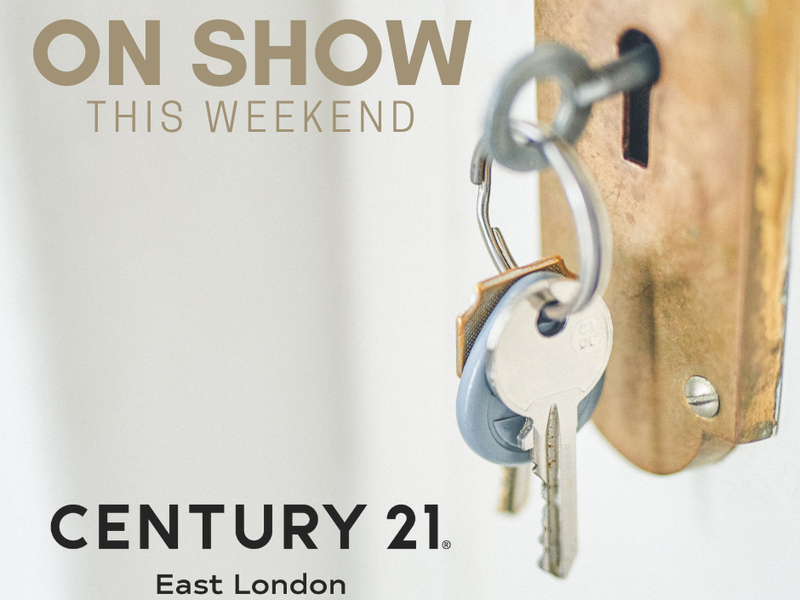A promotional image featuring a key in a lock, used for real estate marketing purposes.
