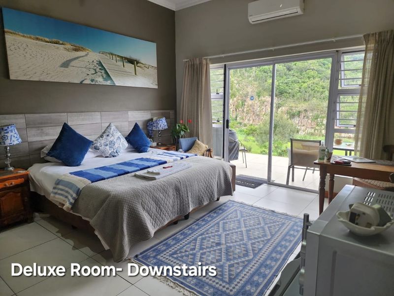 A comfortable bedroom featuring tiled floors, a wood-look headboard, and a large sliding glass door providing direct access to an outdoor patio area.