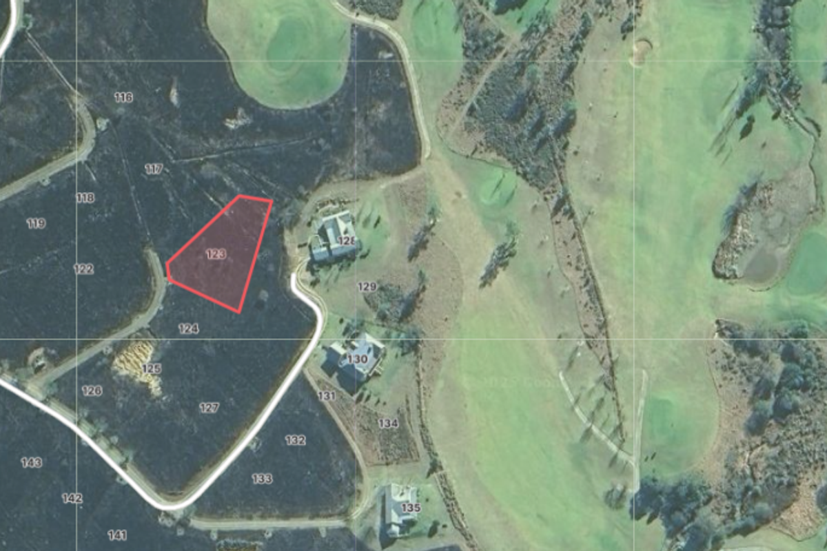 Aerial view of vacant residential land parcel 123, situated within a golf estate development.