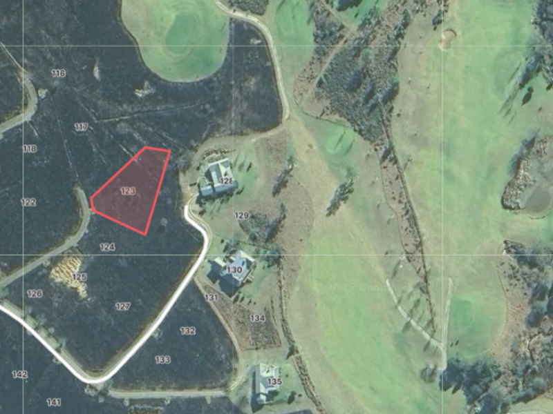 Aerial view of vacant residential land parcel 123, situated within a golf estate development.
