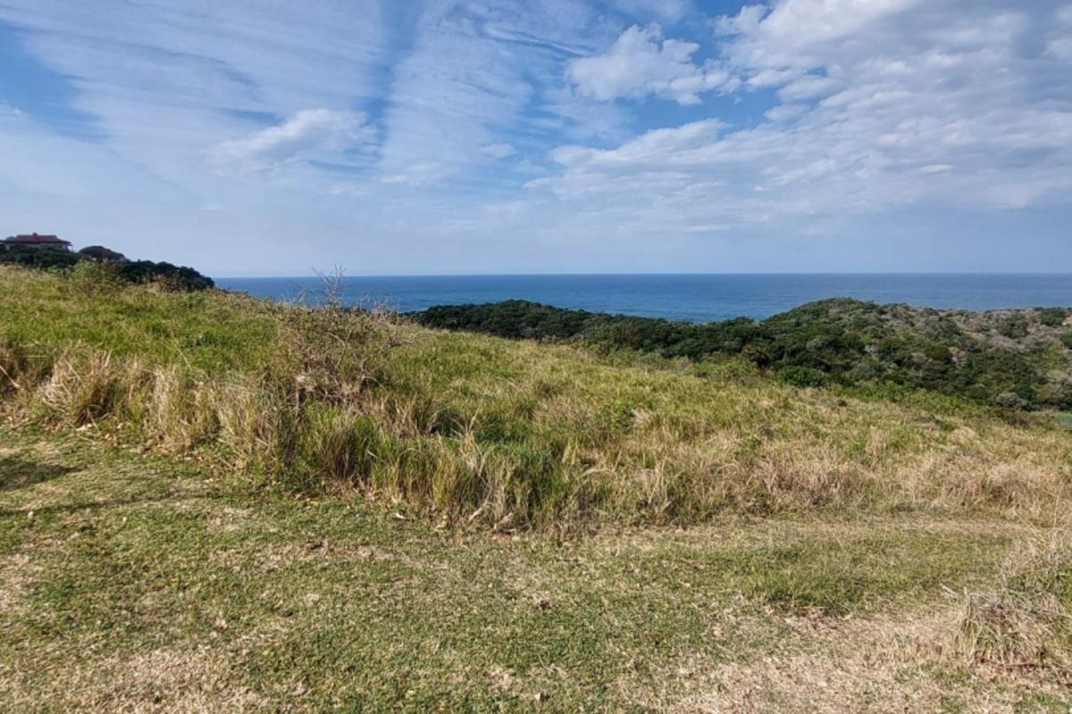 A scenic view of the coastline and ocean from the vacant residential land, showcasing the natural landscape and elevated position.
