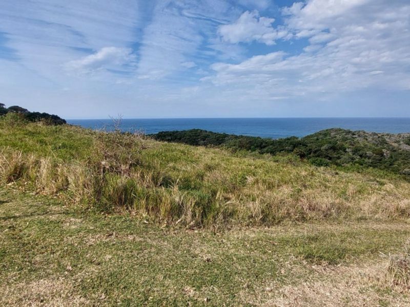A scenic view of the coastline and ocean from the vacant residential land, showcasing the natural landscape and elevated position.