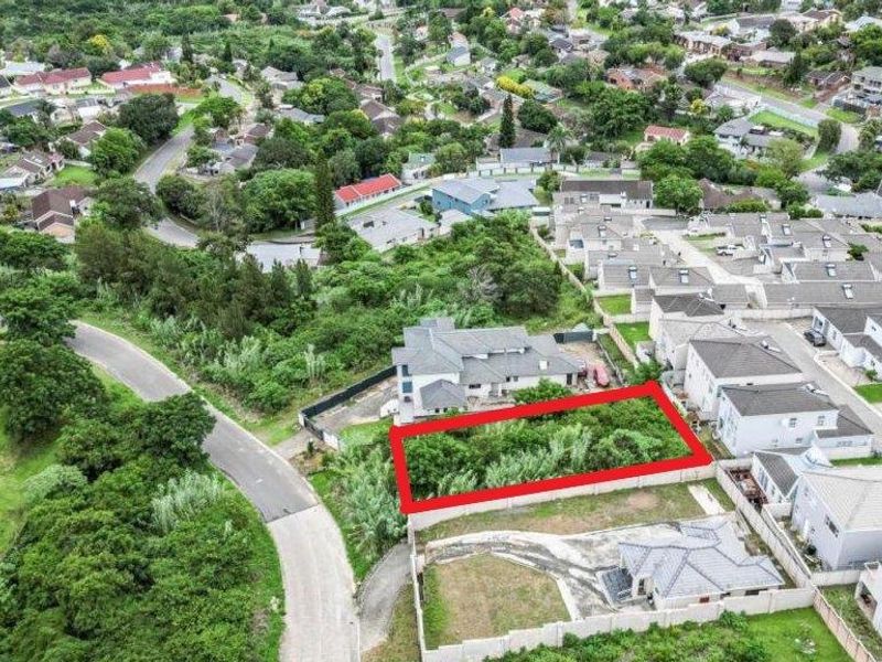 Aerial view of a vacant residential plot situated within an established suburban neighborhood, offering potential for new development.