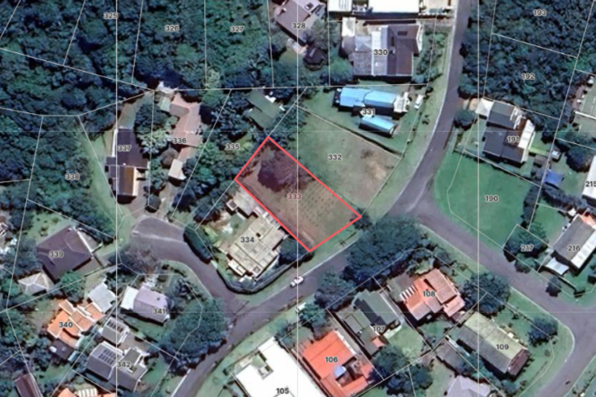 An aerial view of the residential property highlighting the cadastral boundary lines of the vacant land plot within the established neighborhood.