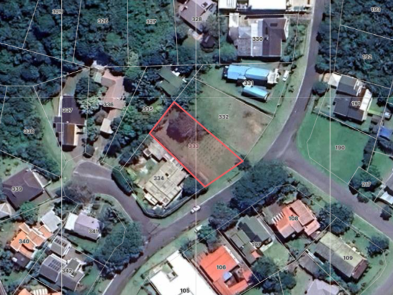 An aerial view of the residential property highlighting the cadastral boundary lines of the vacant land plot within the established neighborhood.