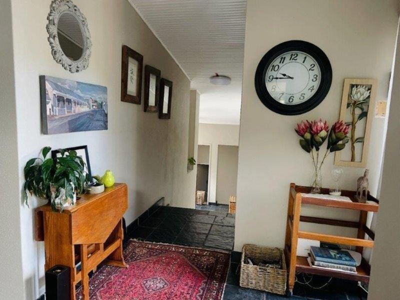 A functional hallway featuring dark slate tile flooring and a beadboard ceiling, providing a transition space between rooms.