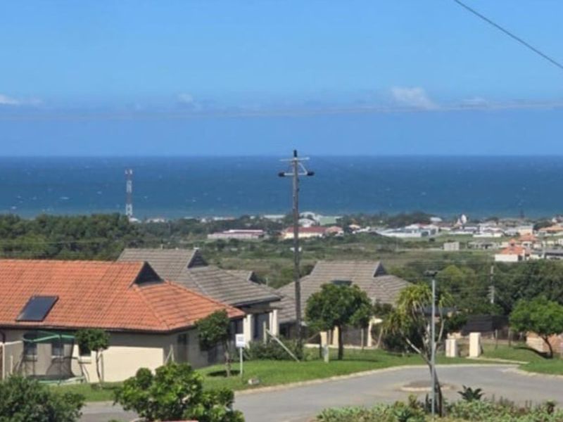 Elevated view overlooking the surrounding residential neighbourhood with a clear outlook towards the distant coastline and ocean.
