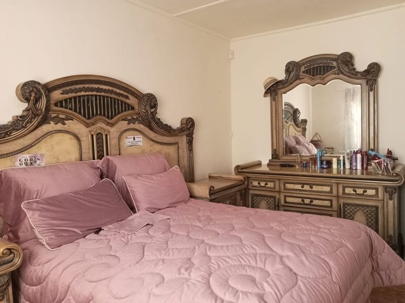 A standard bedroom featuring neutral wall finishes and basic architectural elements, suitable for personalization or modern updates.