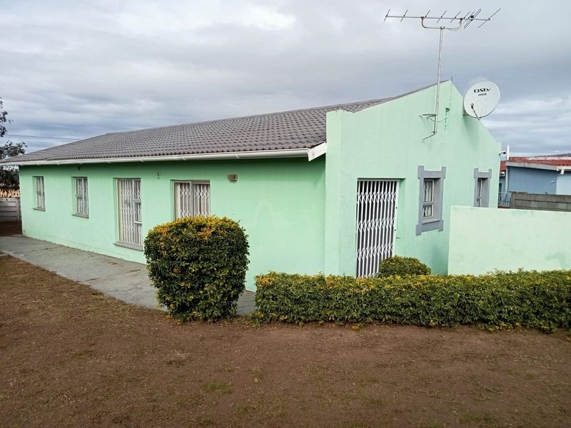Front exterior view of a single-story house featuring a tiled roof, security gates, and satellite dish installation.