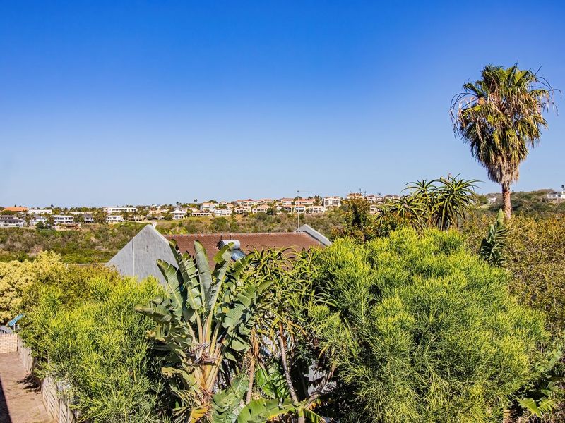 A scenic elevated view overlooking the surrounding residential neighborhood and lush greenery, showcasing the property's peaceful outdoor setting.