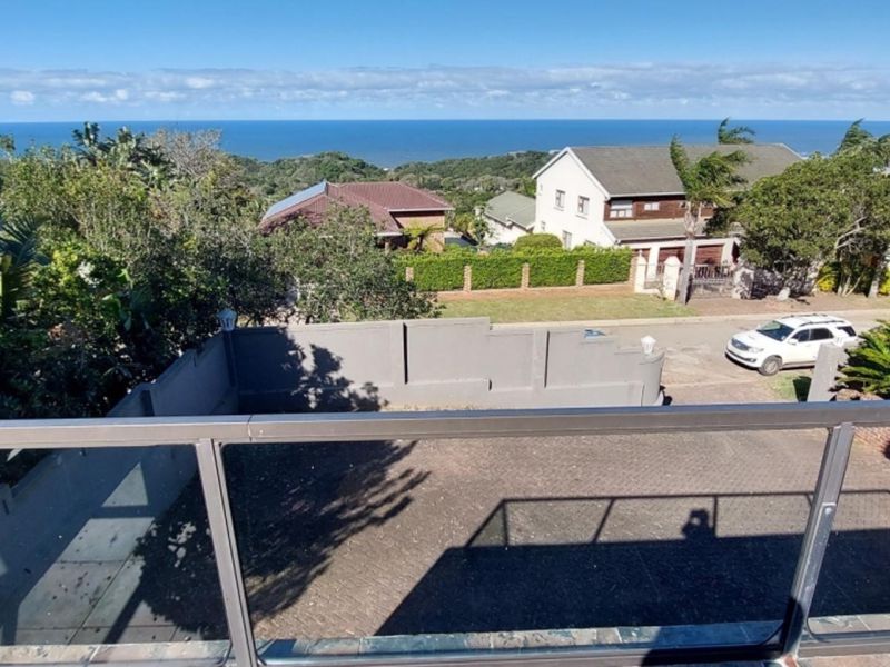 Elevated view overlooking the driveway, surrounding neighbourhood, and distant ocean horizon.
