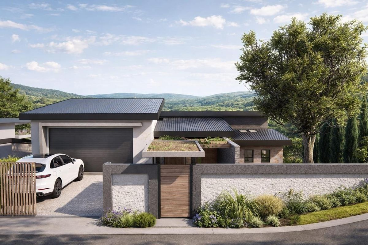 Modern residential facade featuring a sleek metal roof, integrated garage, stone-textured boundary wall, and a timber entrance gate set against a scenic landscape.