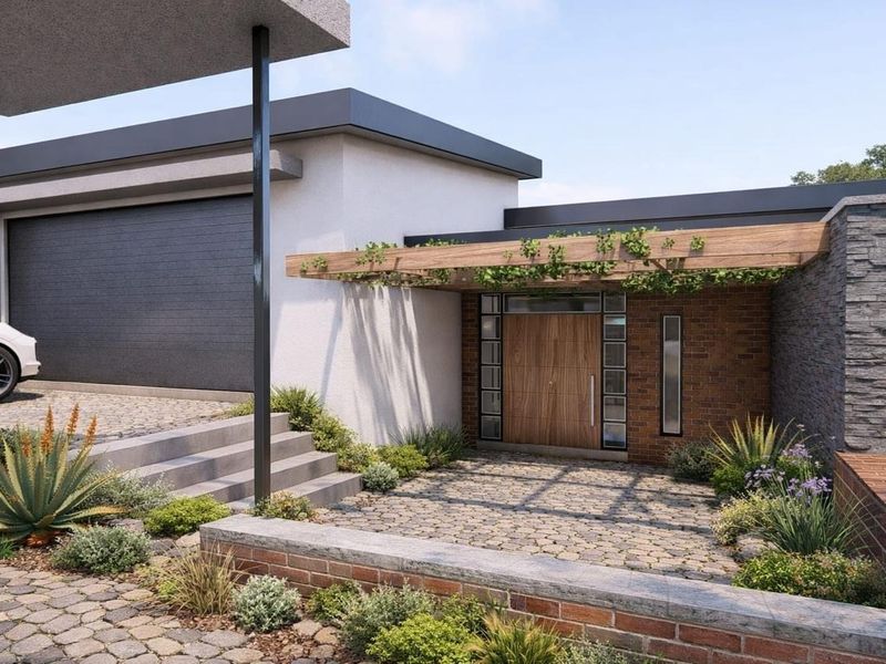 Modern residential front entrance featuring a timber pergola, stone paving, and a contemporary brick and render facade.