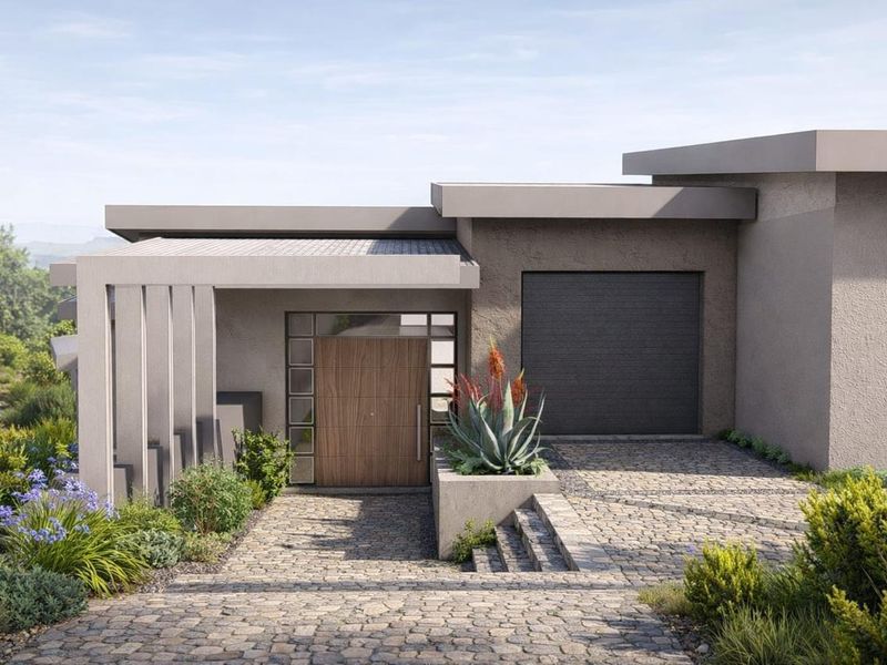 A modern residential front elevation featuring a cobblestone driveway, timber entrance door, and integrated garage, set within a landscaped garden.
