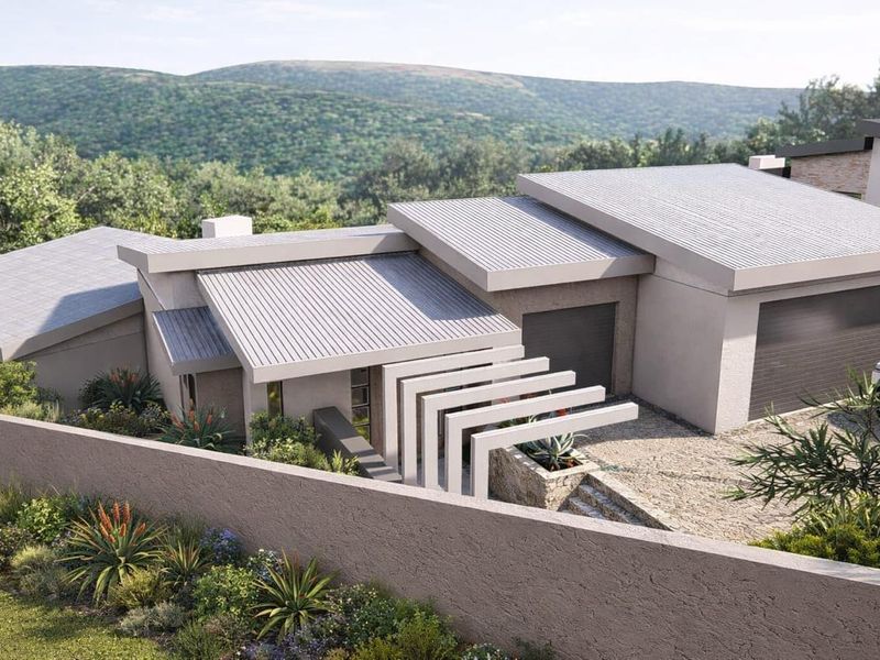 Modern residential property featuring a contemporary architectural design with corrugated metal roofing, stone accents, and a double garage, set against a scenic landscape.