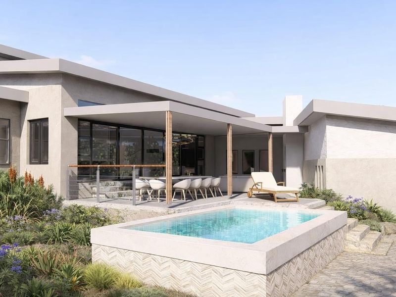 A modern rear exterior view featuring a covered patio, a raised swimming pool with decorative stone tiling, and landscaped garden surroundings.