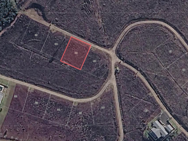Aerial view of a vacant residential land plot, identified as lot 39, situated within a developing estate with established road access.