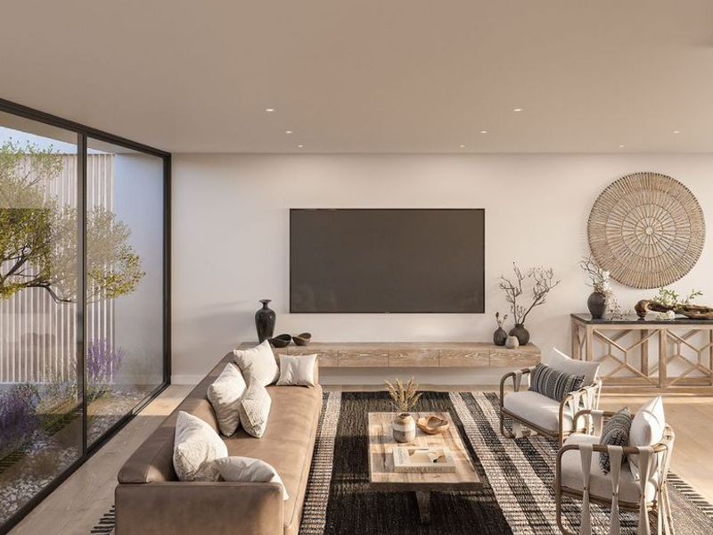 Modern open-plan living and dining area featuring floor-to-ceiling glass walls, recessed lighting, and a sleek floating media console.
