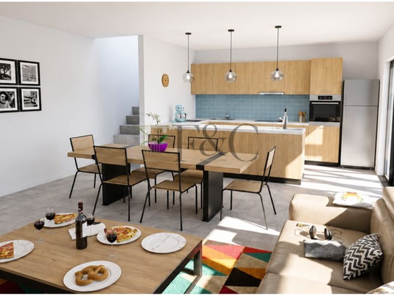 Modern open-plan living and dining area featuring a contemporary kitchen with light wood cabinetry, integrated appliances, and a functional kitchen island.