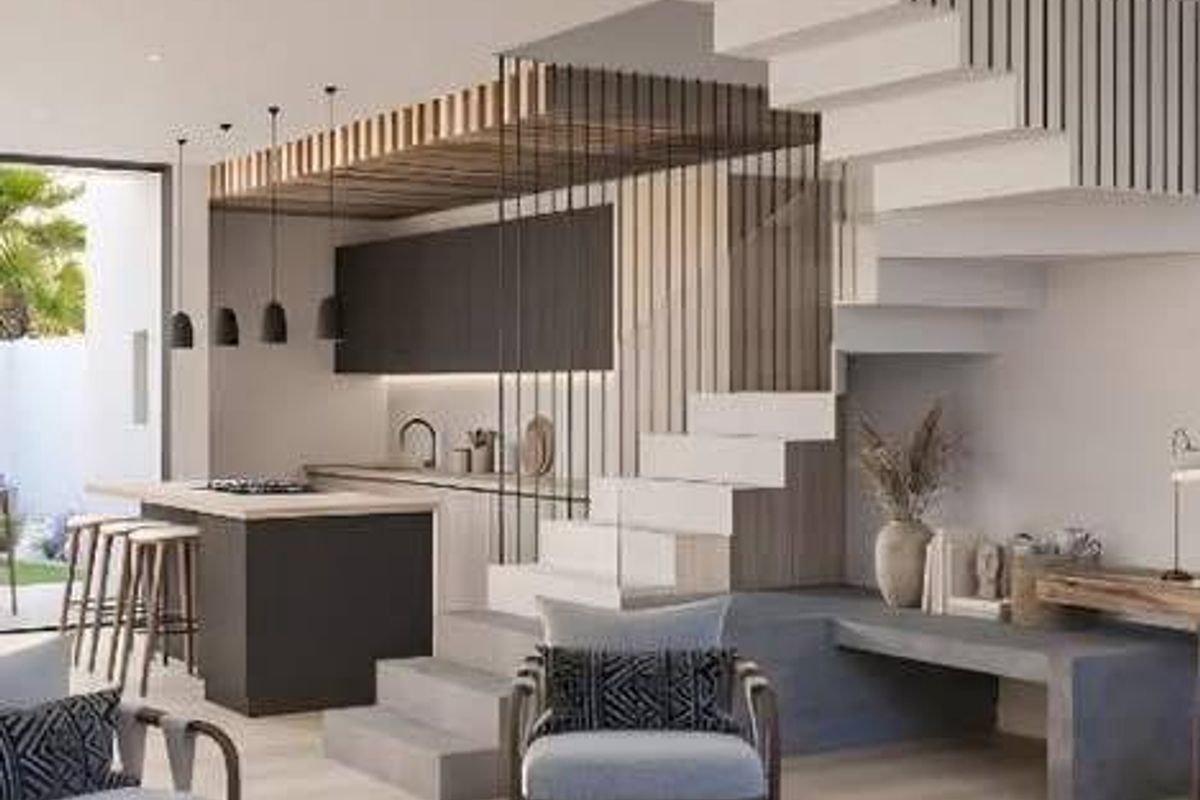 Modern open-plan living area featuring a sleek kitchen with island, architectural staircase, and contemporary finishes throughout.