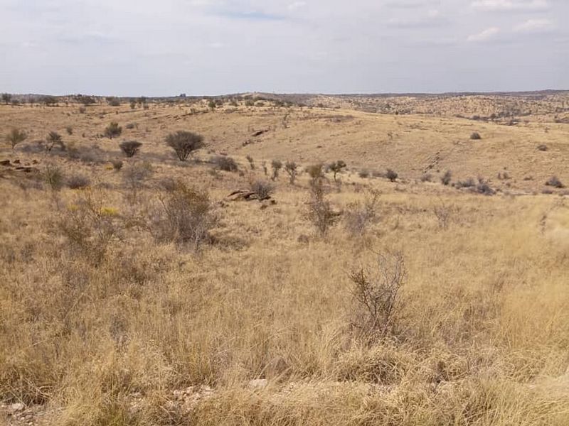 A wide-angle view of the expansive, dry, and undeveloped residential land featuring natural veld vegetation and rolling terrain.