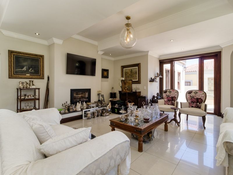Spacious living room featuring tiled flooring, a built-in fireplace, recessed lighting, and large sliding glass doors providing access to the outdoor area.