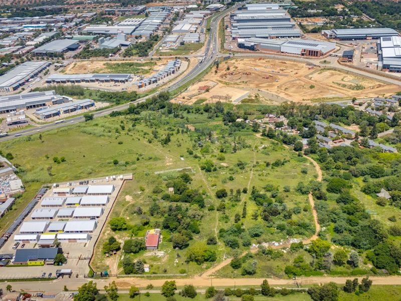 Aerial view of a large vacant commercial land parcel situated within a developed industrial and commercial precinct.