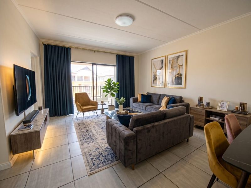 A well-maintained living room featuring tiled flooring and a large sliding glass door that provides access to an outdoor balcony area.