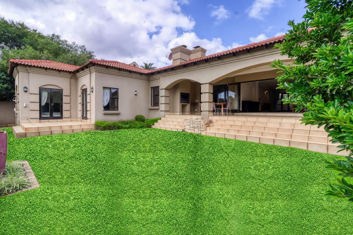Spacious rear exterior view featuring a covered patio with built-in braai, tiled steps, and a well-maintained garden area.