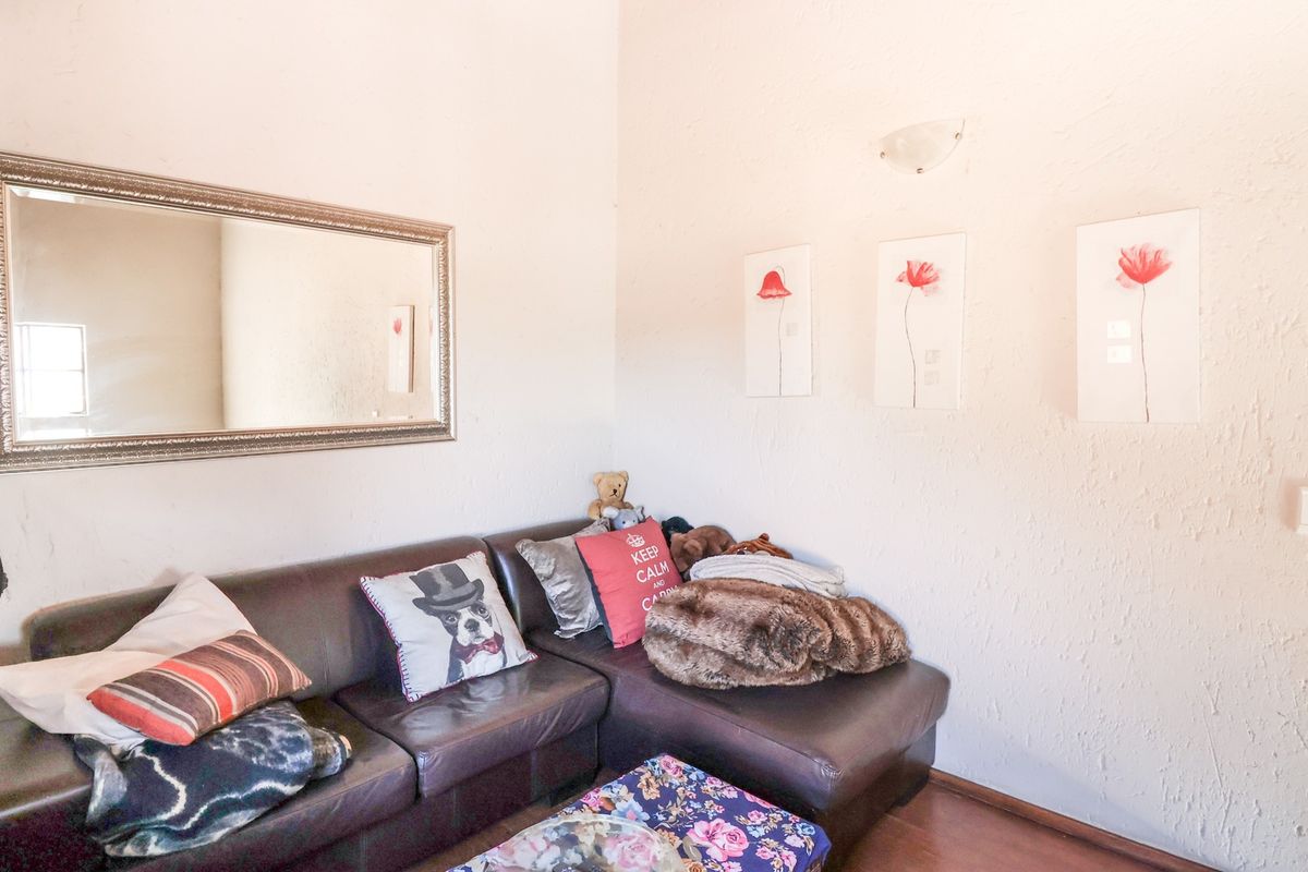 A cozy living room area featuring textured walls and a wall-mounted light fixture, providing a comfortable space for relaxation.