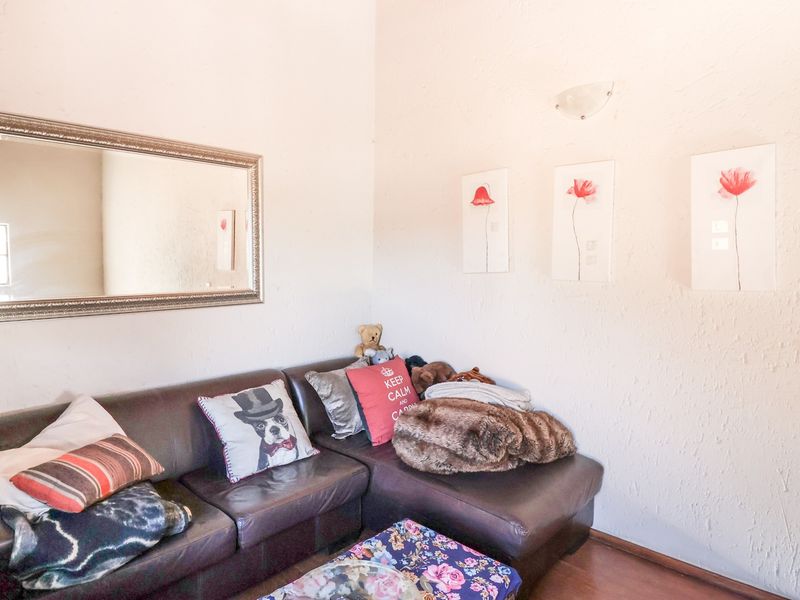 A cozy living room area featuring textured walls and a wall-mounted light fixture, providing a comfortable space for relaxation.