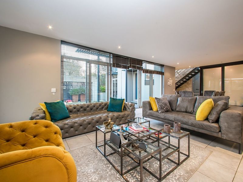 Spacious living room featuring large sliding glass doors that provide ample natural light and direct access to the outdoor patio area.