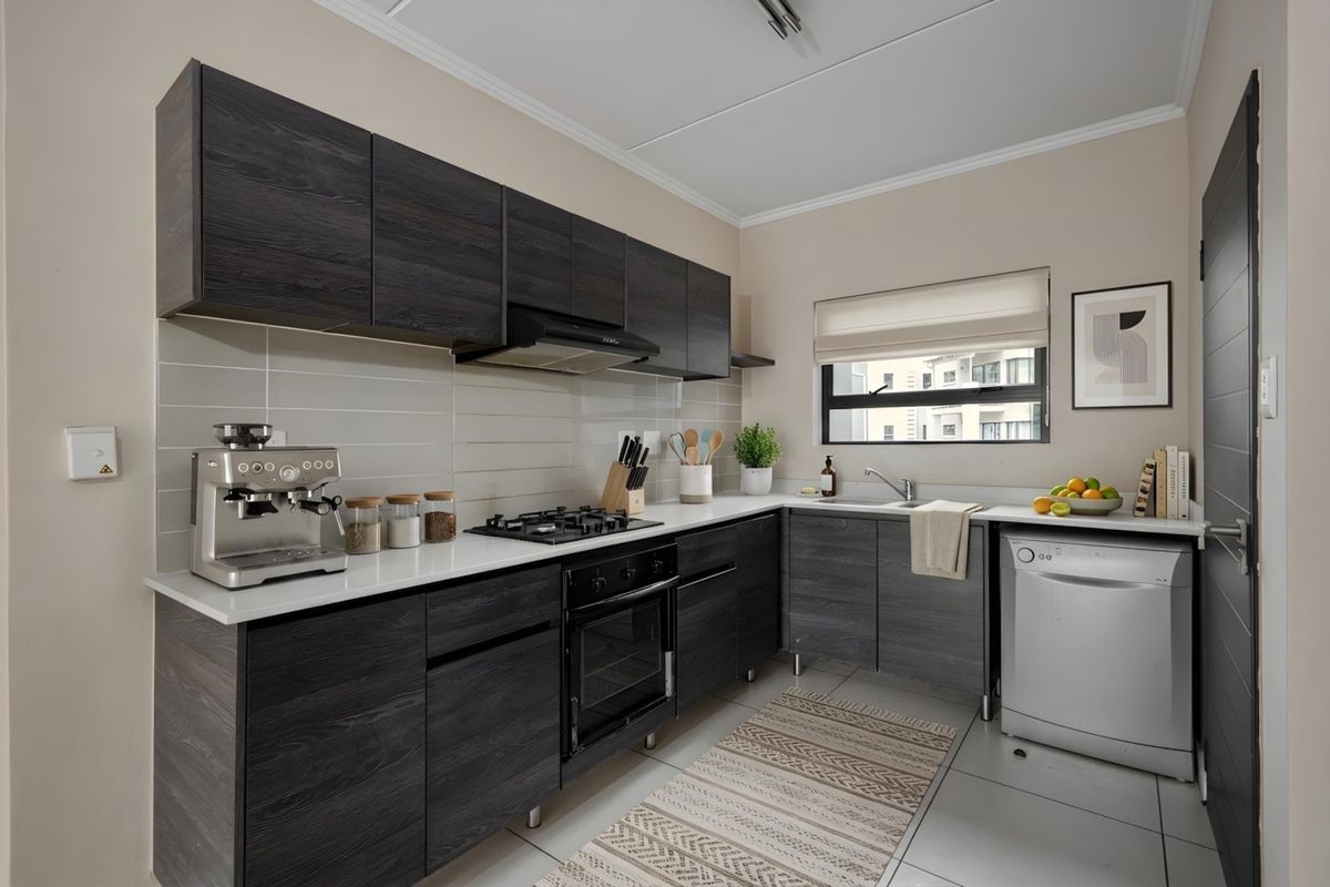 Modern kitchen featuring dark wood grain cabinetry, white stone countertops, built-in gas hob, oven, and integrated sink with tiled backsplash and flooring.