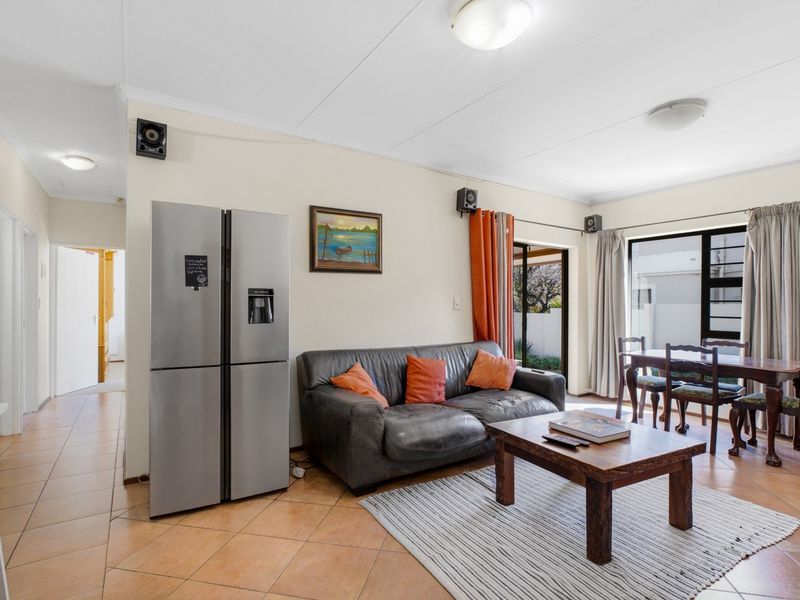 Open plan living and dining area featuring tiled flooring and sliding glass doors providing access to the outdoor space.