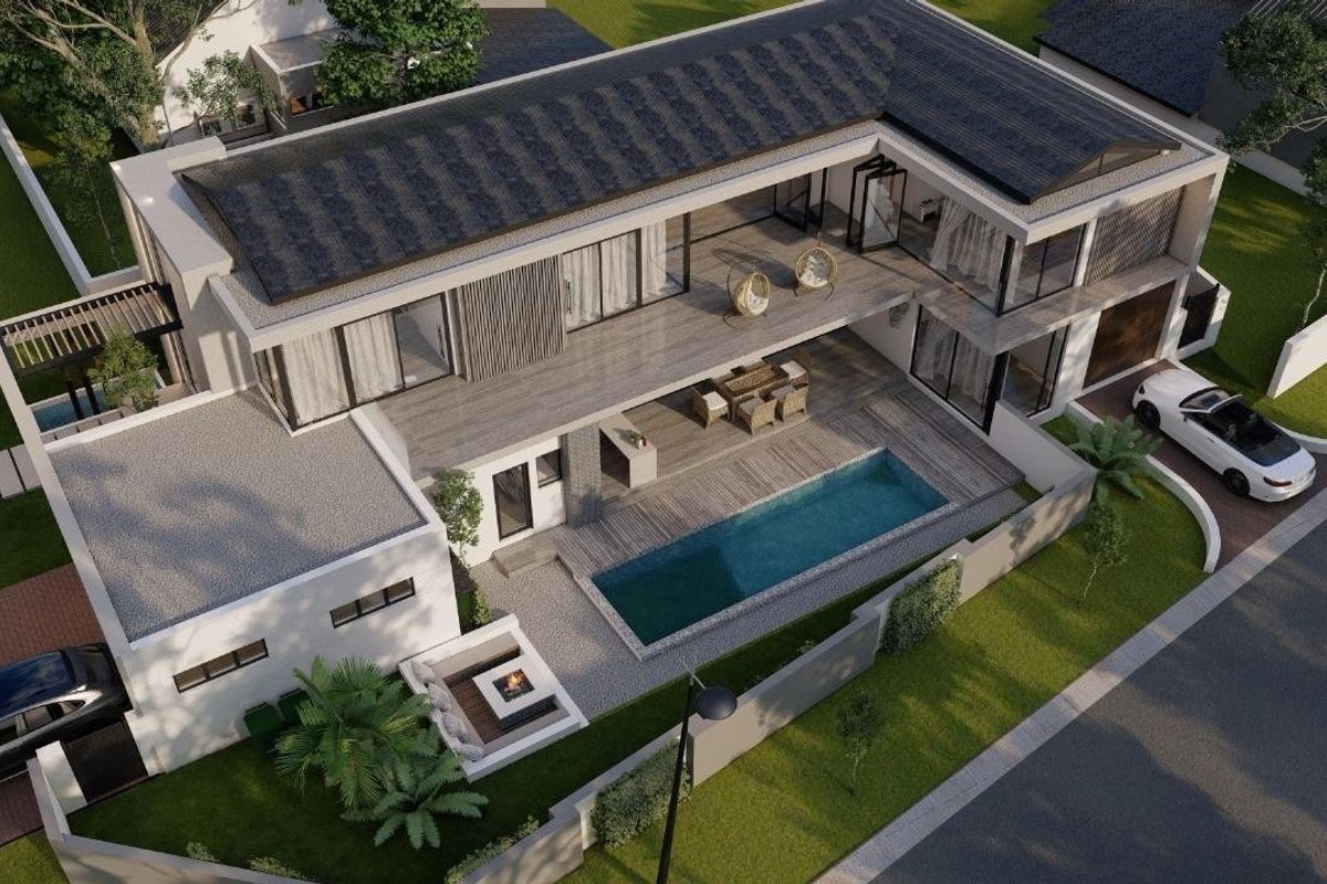 Aerial view of a modern residential property featuring a swimming pool, spacious deck, balcony, and secure boundary wall.
