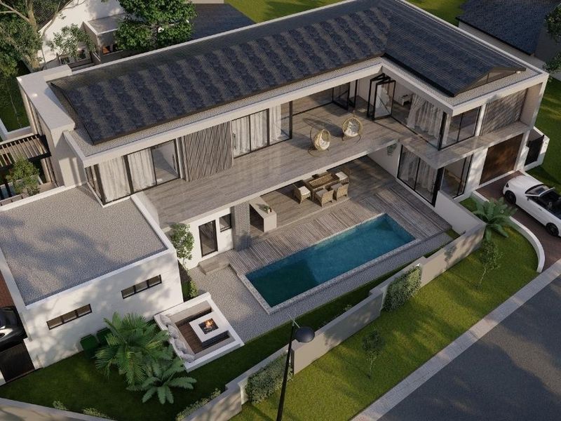Aerial view of a modern residential property featuring a swimming pool, spacious deck, balcony, and secure boundary wall.