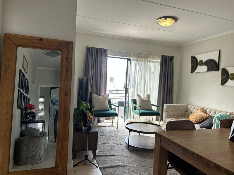 Open plan living area featuring tiled flooring and a sliding glass door providing access to the balcony.