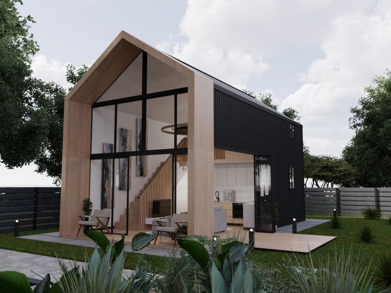 Modern townhouse featuring a striking timber-framed facade, floor-to-ceiling glass, and black metal cladding, opening onto a private timber deck and garden area.