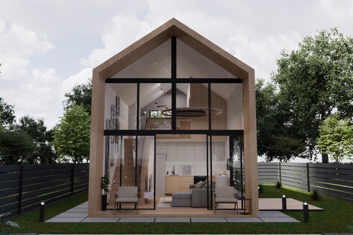 A modern townhouse rear elevation featuring a striking floor-to-ceiling glass facade, timber frame construction, and a private garden with paved patio area.
