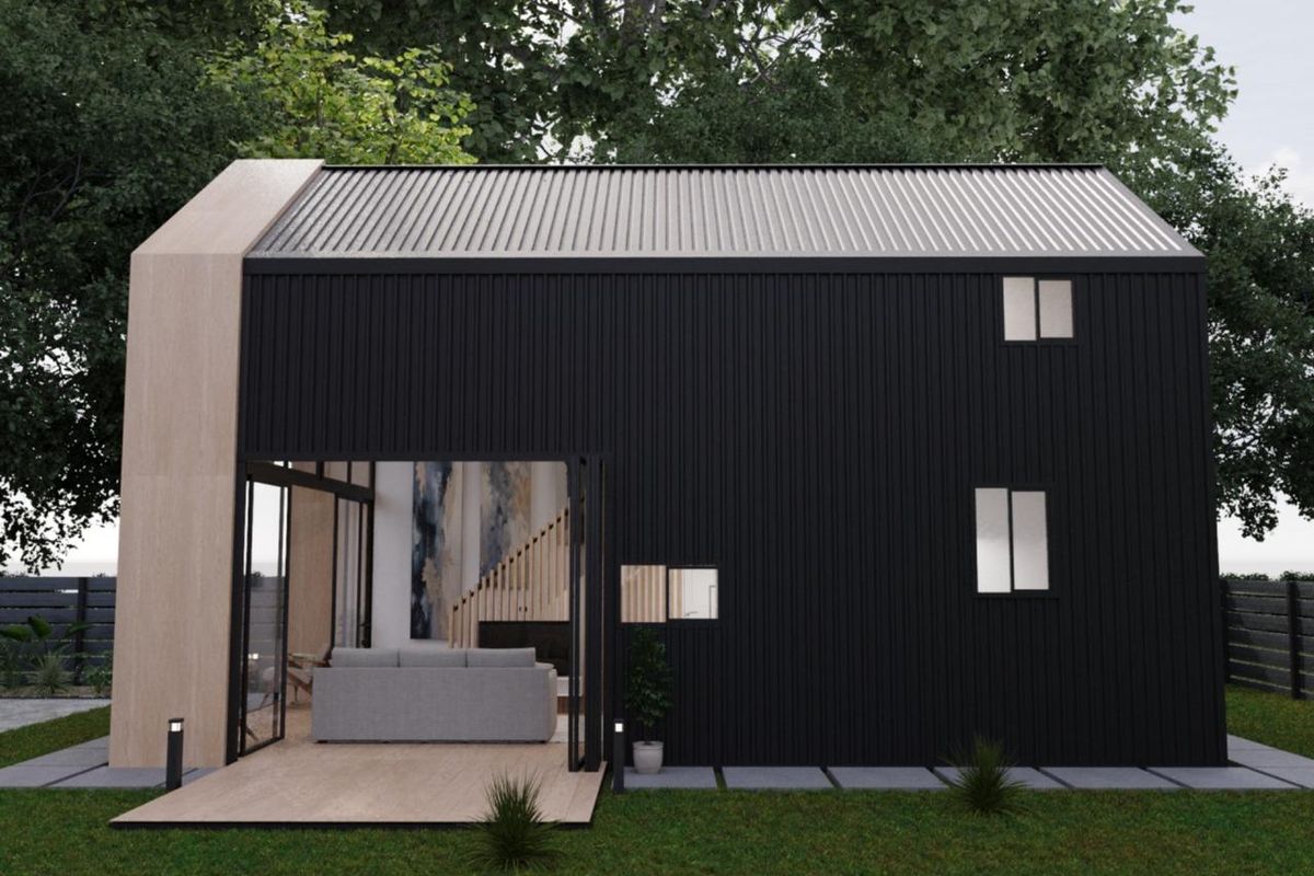 Modern rear exterior view of a townhouse featuring black metal cladding, timber accents, a private deck, and large sliding glass doors.