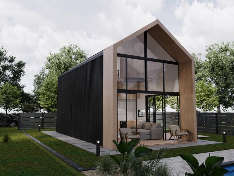 Modern architectural townhouse featuring a striking timber-framed facade, floor-to-ceiling glass walls, and a sleek black corrugated metal exterior set within a landscaped garden.