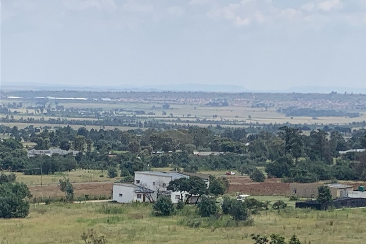 An elevated aerial view of the surrounding landscape and rural residential property.
