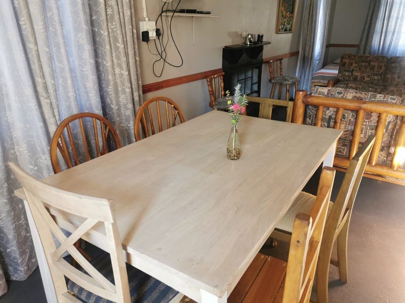 A dining area featuring a fireplace and chair rail molding, providing a functional space for meals within the home.